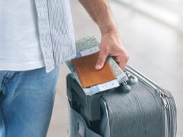 Man Holding His Passport And Carrying Suitcase, Close Up
