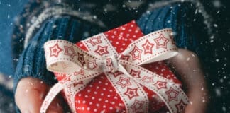 Close Up Shot Of Female Hands Holding A Small Gift