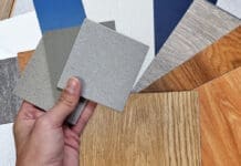 Interior Designer's Hand Holding Quartz Stone Samples Matching Color With Wood Vinyl Flooring Tiles, Engineering Wood Tiles, Stone Tiles, Solid Color Laminateds, Artificial Stone Tiles. Close Up View.