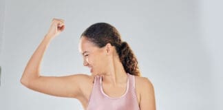 Scale, Success And Strong Woman With Fitness, Lose Weight Progress And Body Goals Or Fist, Power And Bodybuilder. Sports Person Or Model For Achievement, Diet And Yes Sign On Studio, White Background