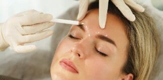 Doctor Making Marks On Client's Face Before Filler Injection