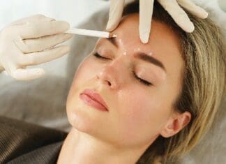 Doctor Making Marks On Client's Face Before Filler Injection