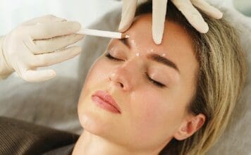 Doctor Making Marks On Client's Face Before Filler Injection