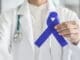 Why Everyone Needs to Talk about Colorectal Cancer Screening at 45 Dark Blue Ribbon For Colon Colorectal Cancer Awareness On Medical Doctor's Hand Support
