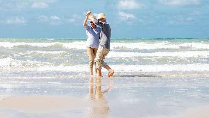 Asian Senior Couple Dancing On The Beach
